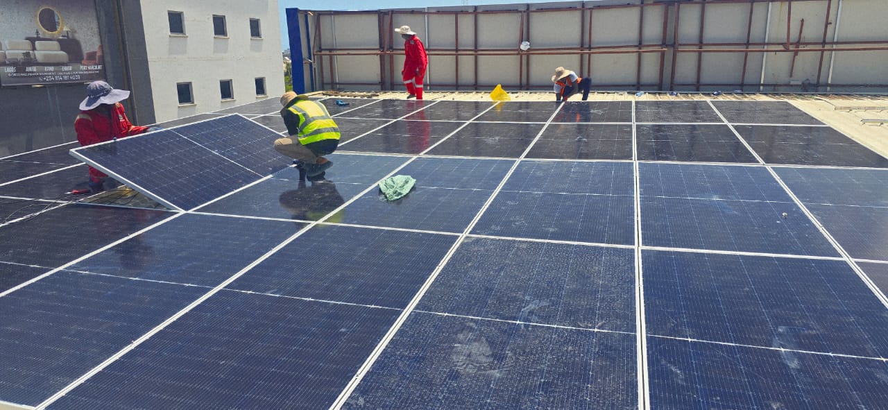 Solar panels installed across a commercial rooftop in Lagos